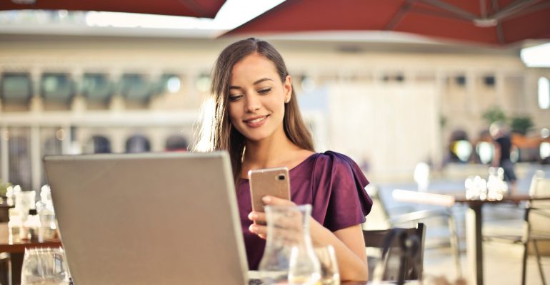 woman-wearing-purple-shirt-holding-smartphone-white-sitting-826349 (1)